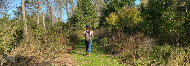person walking through Kishwauketoe Nature Conservancy