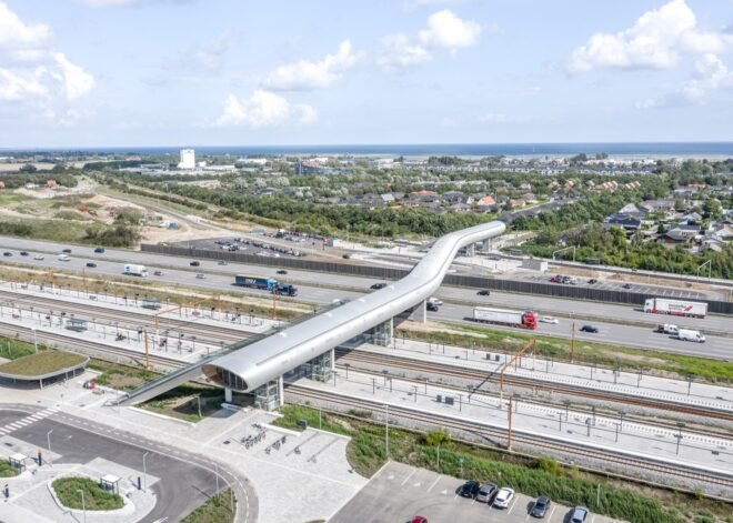 long metal tube structure elevated above a highway