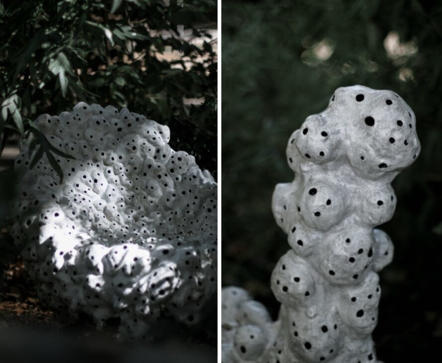 white sculptures with holes in nature