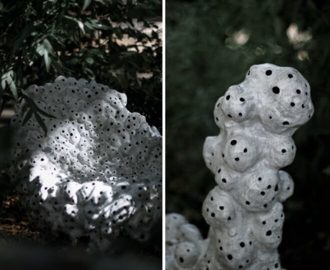 white sculptures with holes in nature