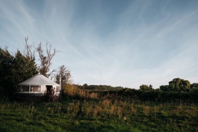 white yurt home on grassy lot