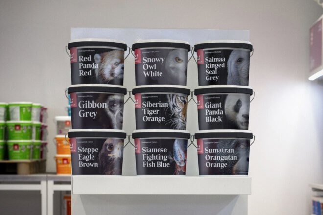 paint buckets with animals on cover shelved at store