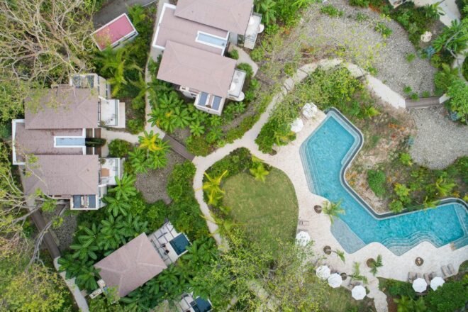 aerial view of beachfront hotel bungalows and swimming pool
