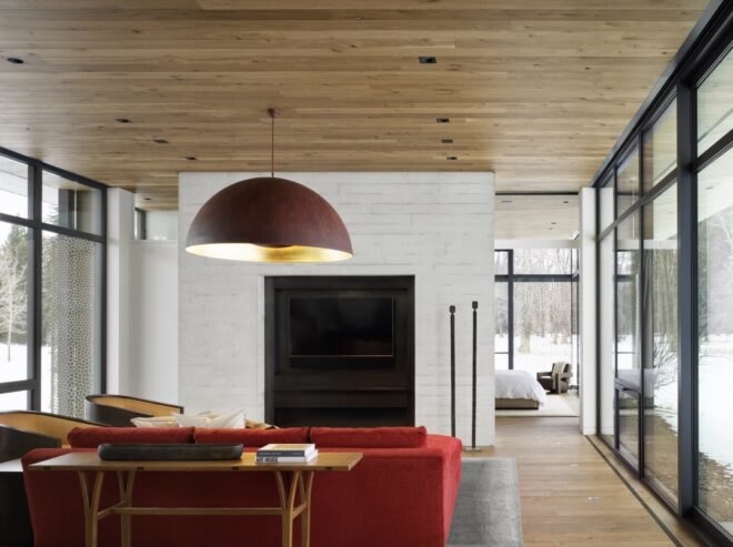 interior of home with wooden floors and ceilings and red furniture