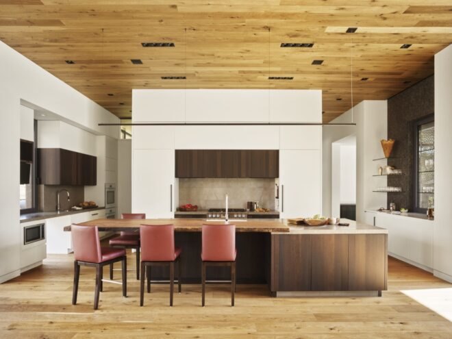 interior of home with wooden floors and ceilings, with red chairs
