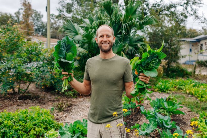 Rob in garden holding greens