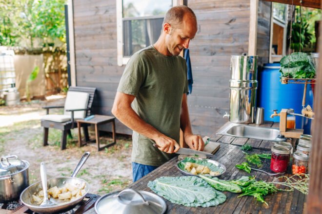 Rob preparing meal in outdoor kitchen