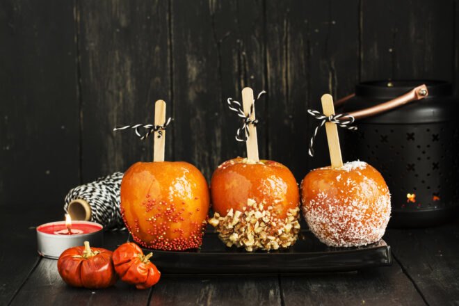 candied apples on a black platter