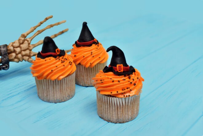cupcakes with orange frosting and witch hats
