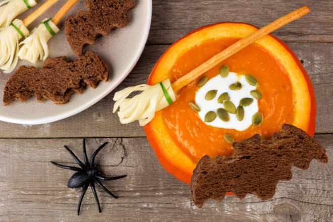 pumpkin soup in a pumpkin with bat-shaped bread