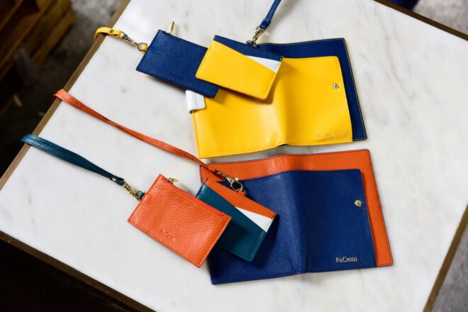 colorful passport holders and wallets on a table