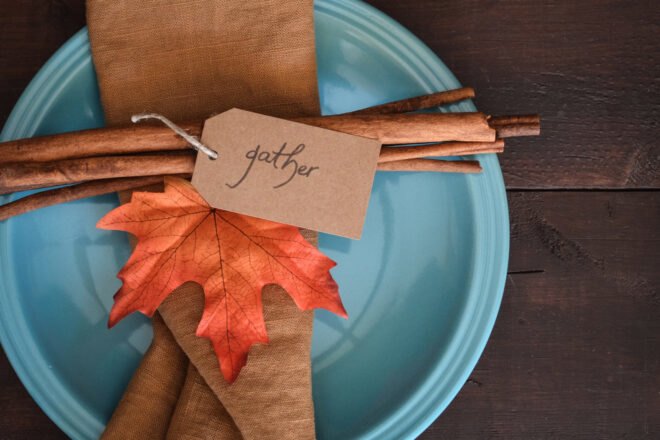 cinnamon, leaf and a brown cloth napkin on a blue plate