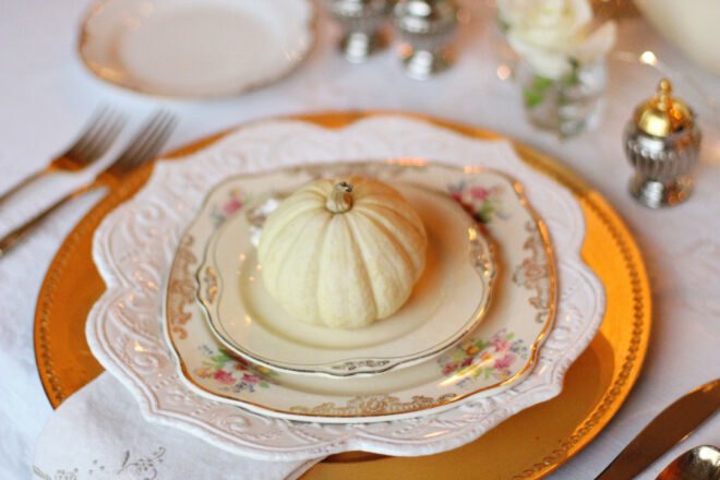 pumpkin on top of layered vintage plates