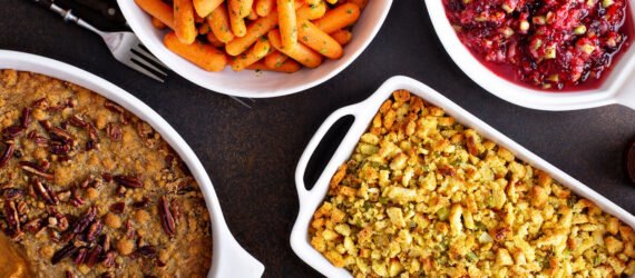 All traditional Thanksgiving side dishes, roasted carrots, sweet potato casserole, cranberry sauce and stuffing
