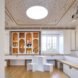 free-standing white cube-shaped seating in a white and light wood room