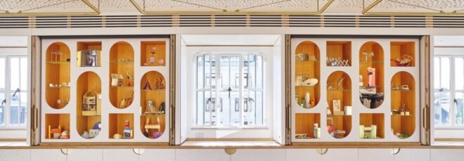 white room with oval-shaped cut-outs in the wall revealing shelves