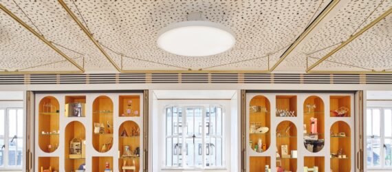 white room with oval-shaped cut-outs in the wall revealing shelves