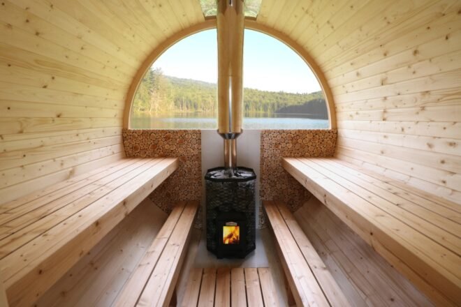 interior of oval-shaped wooden sauna with wood-burning stove