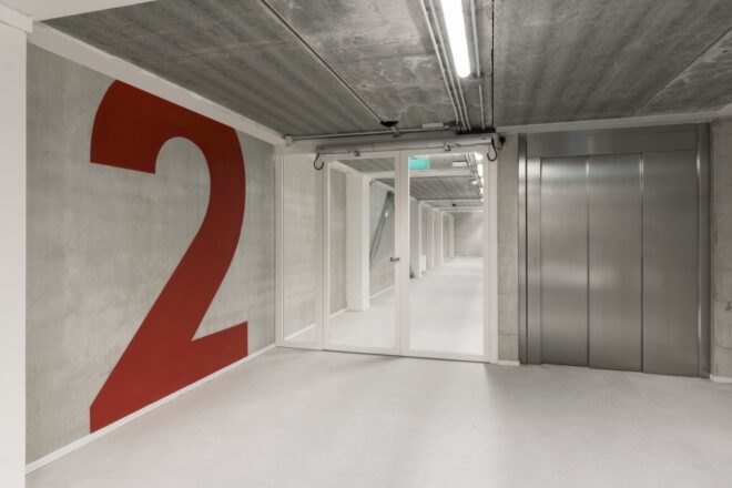 white room with giant number 2 painted in red on one wall