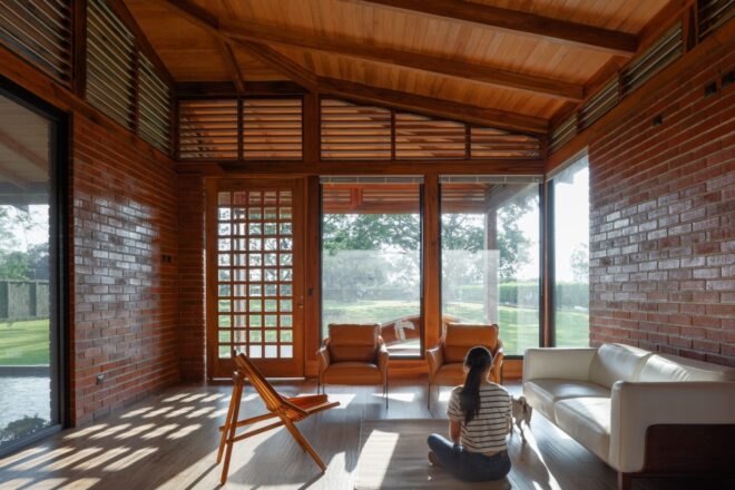 an indoor space with large glass facades and a white sofa