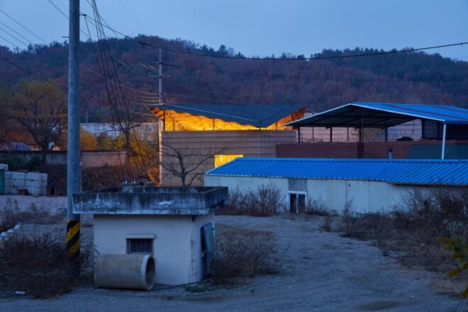 neighborhood with one home lit up at night
