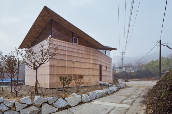 small tan home with butterfly roof