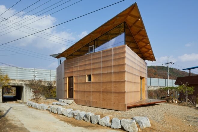 tan and glass home with butterfly roof