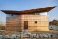 tan home with butterfly roof