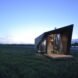 angular tiny home in green landscape at dusk