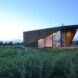 angular tiny home in green landscape