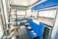 tiny home living area with bright blue kitchen