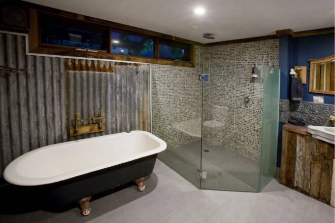 large bathroom with claw-foot bathtub and glass-enclosed shower