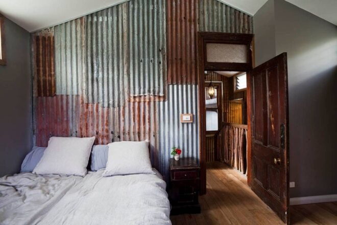 bedroom with twin beds and metal walls