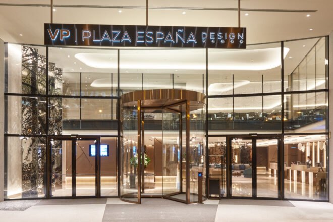 hotel entrance with glass walls and sign that reads VP Plaza España Design