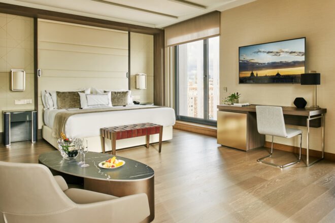 beige hotel room with large window
