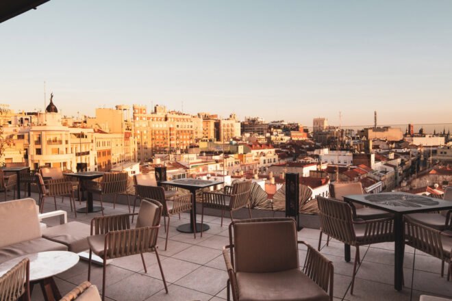 tan chairs and small tables on an outdoor patio