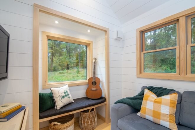 reading nook with gray bench near a window