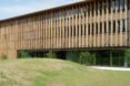 long timber building with first floor made with glass walls