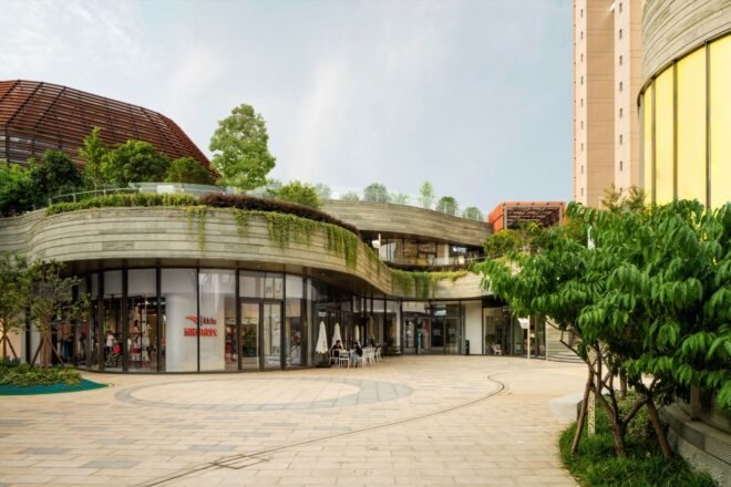 storefronts of a mall topped with plants