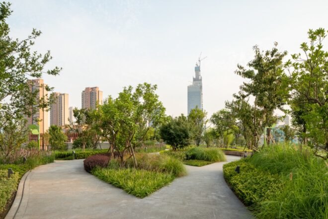 walkways and greenery with cityscape in background