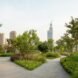 walkways and greenery with cityscape in background