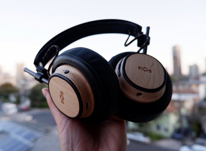 hand holding wood headphones