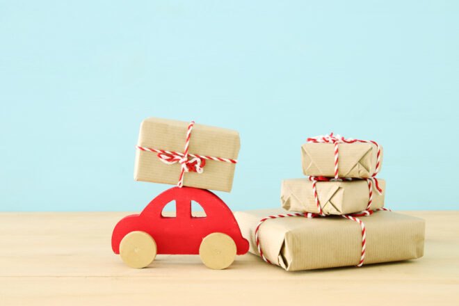 red wood car near butcher paper-wrapped gifts