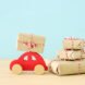 red wood car near butcher paper-wrapped gifts