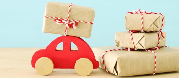 red wood car near butcher paper-wrapped gifts