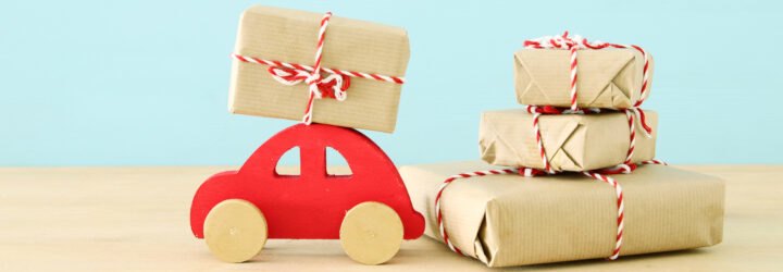 red wood car near butcher paper-wrapped gifts