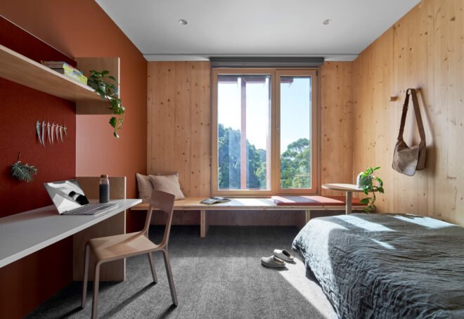 student dorm with red and wood walls and a large window