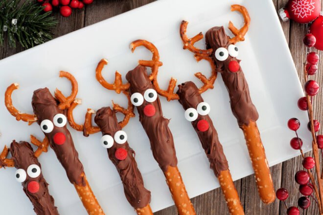 chocolate-covered pretzel sticks with candies to make them look like reindeer