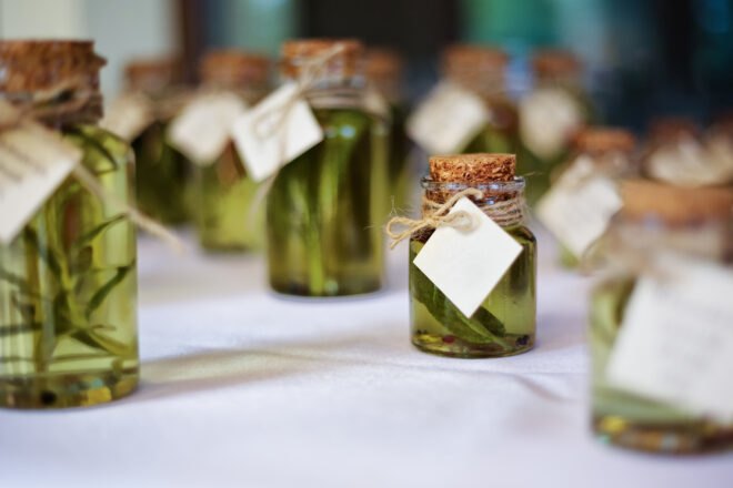 homemade infused olive oils in small glass jars tied with string