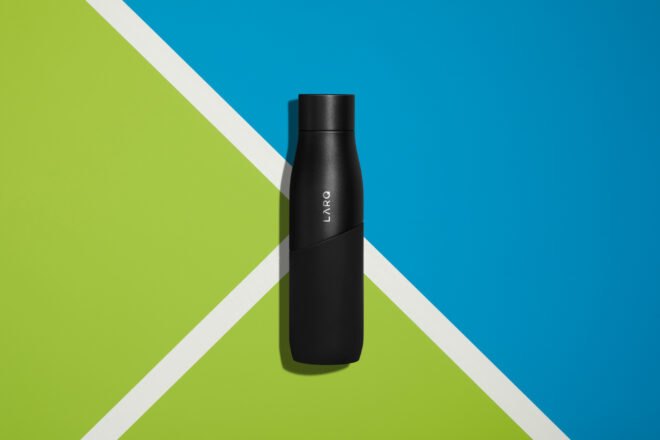 black water bottle on blue and green background